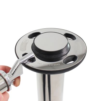 Top part of a stainless steel pole with a quick-release mechanism for a cross rail, featuring a circular plate with oval cutouts and a central button. Includes visible text 'PAT. 2473843,' illustrating the design and functionality of the quick-release mechanism for easy assembly and disassembly.